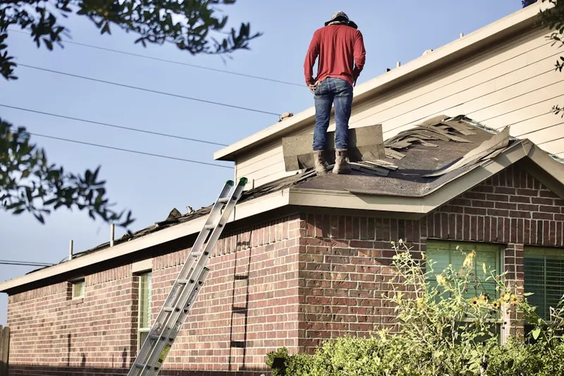 Professional roofer working on a residential roof in The Woodlands